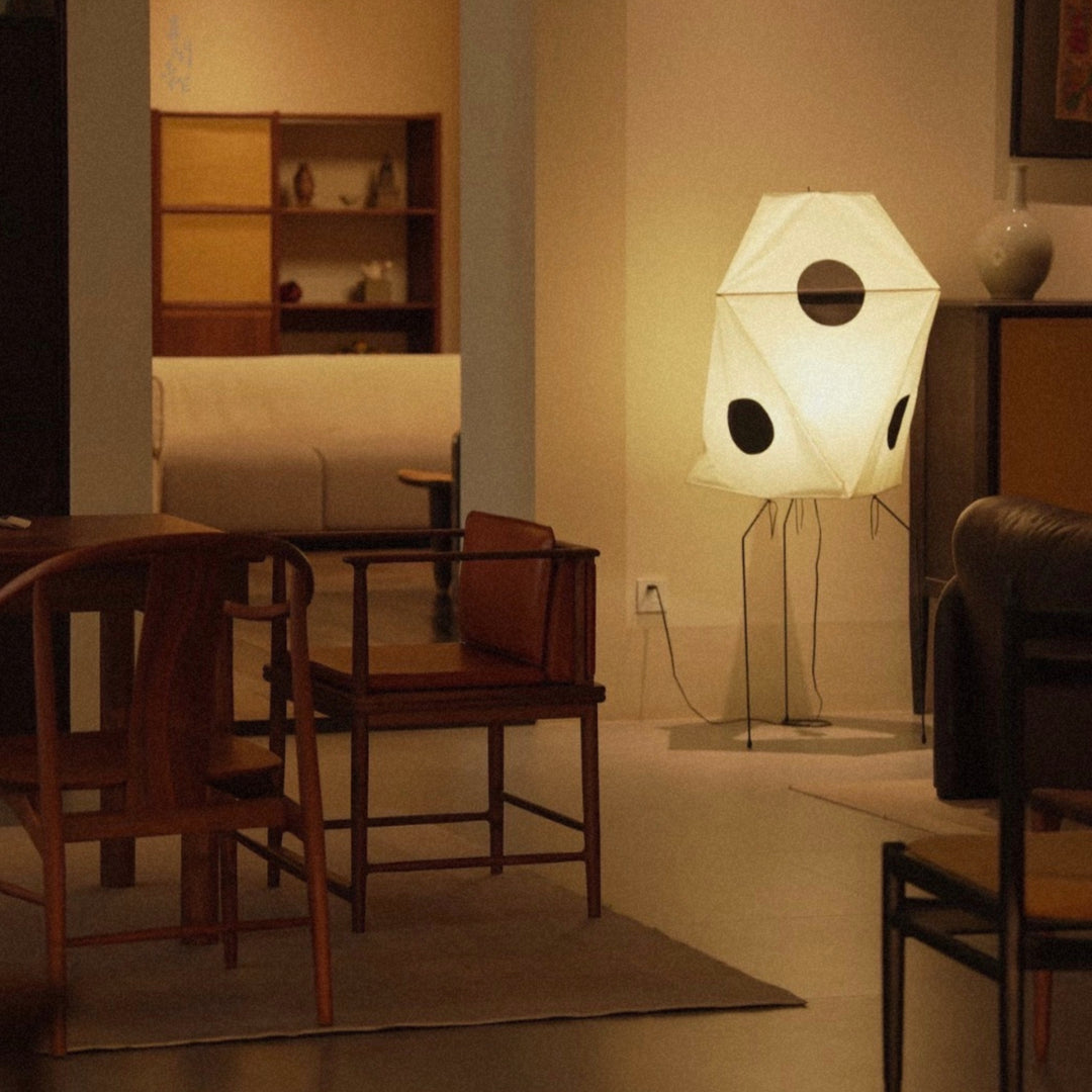 paper floor lamp glowing in a dim room creating a calm evening atmosphere.