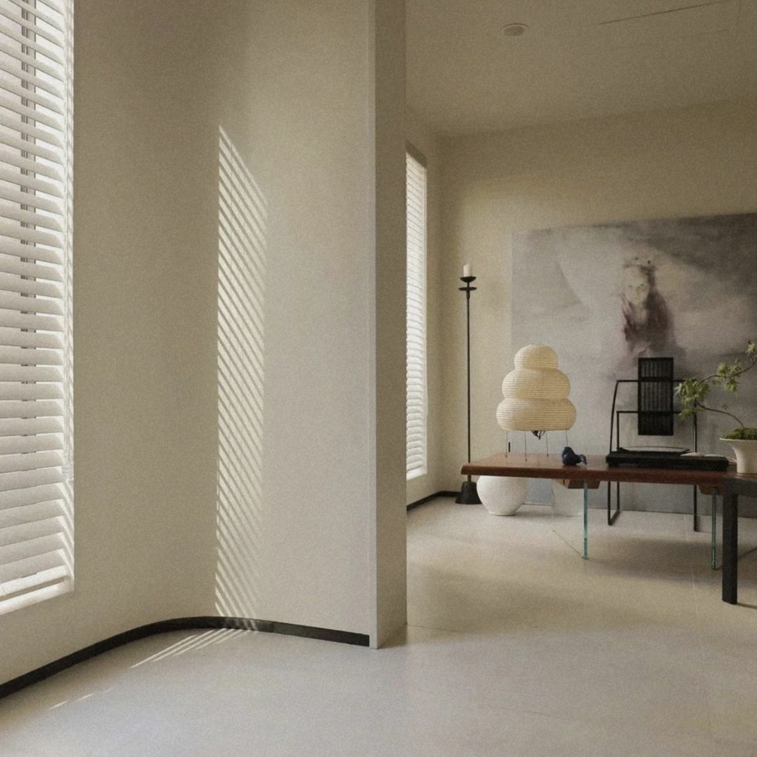paper lantern floor lamp standing in an open room near large windows.