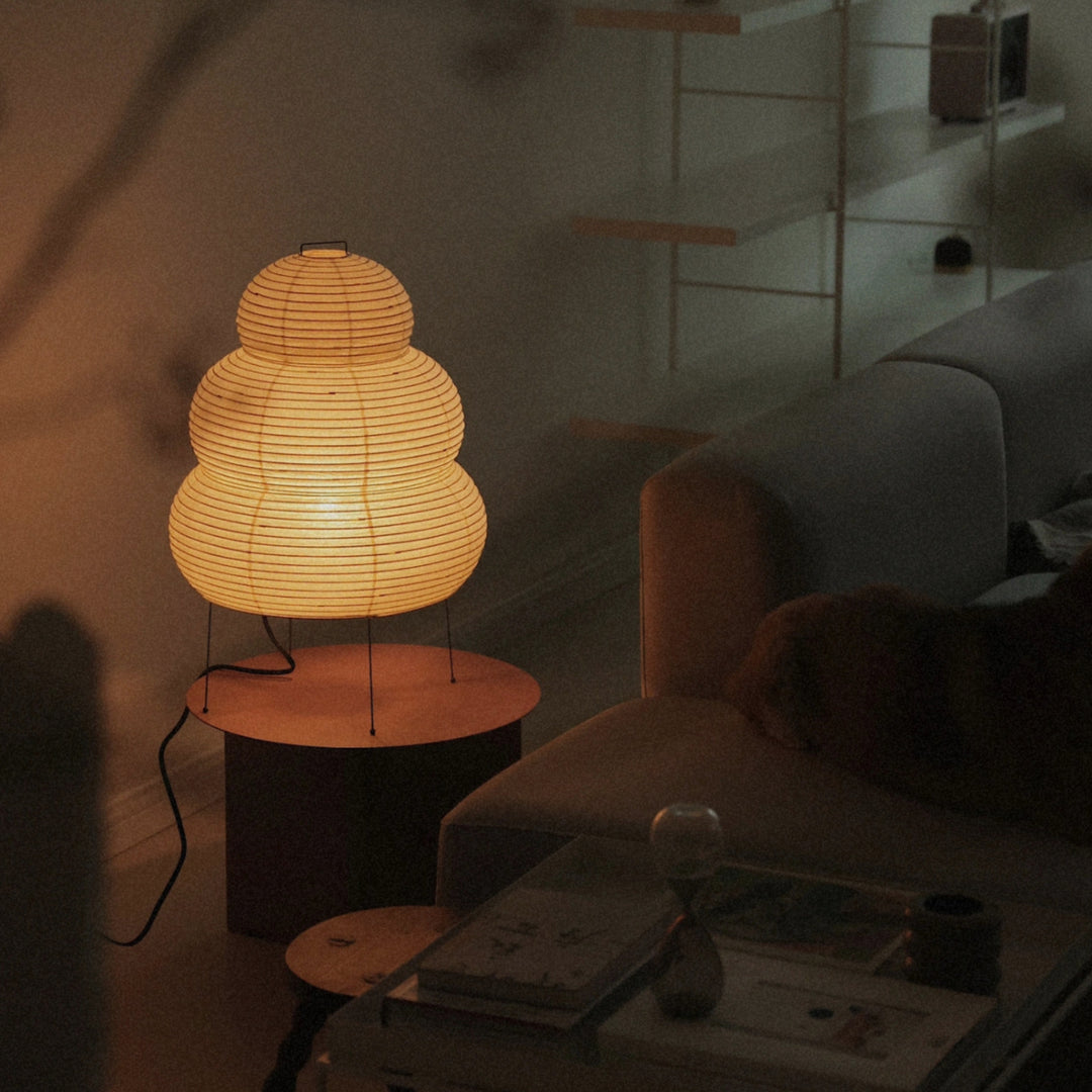 paper lantern lamp resting on a round table in a relaxed living room corner.
