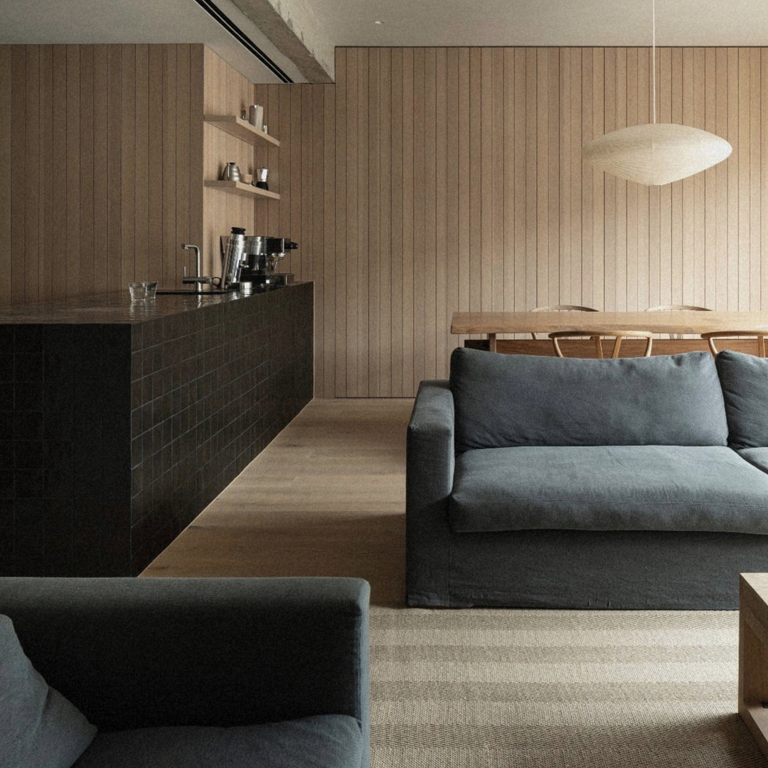 paper shade pendant light hanging in a lounge area beside a seating arrangement.