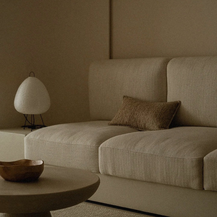 paper shade table lamp placed near a sofa creating a relaxed atmosphere in the room.