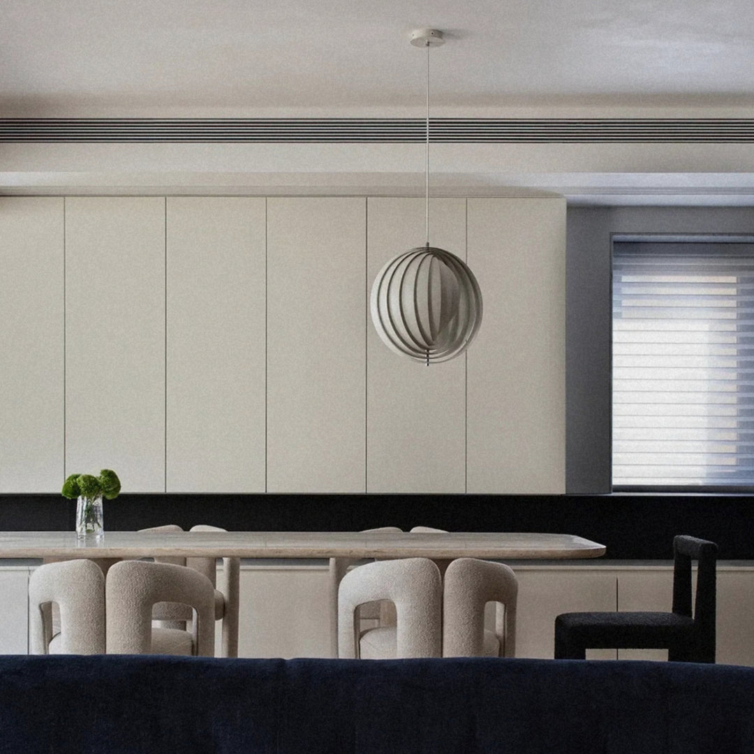 pendant light suspended above a seating area in a minimal living room.