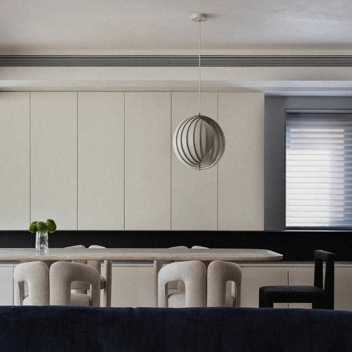 pendant light suspended above a seating area in a minimal living room.