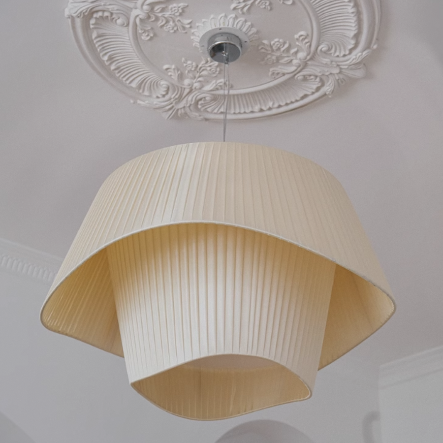 Pendant lamp with a pleated design, inspired by origami, illuminating a modern interior.