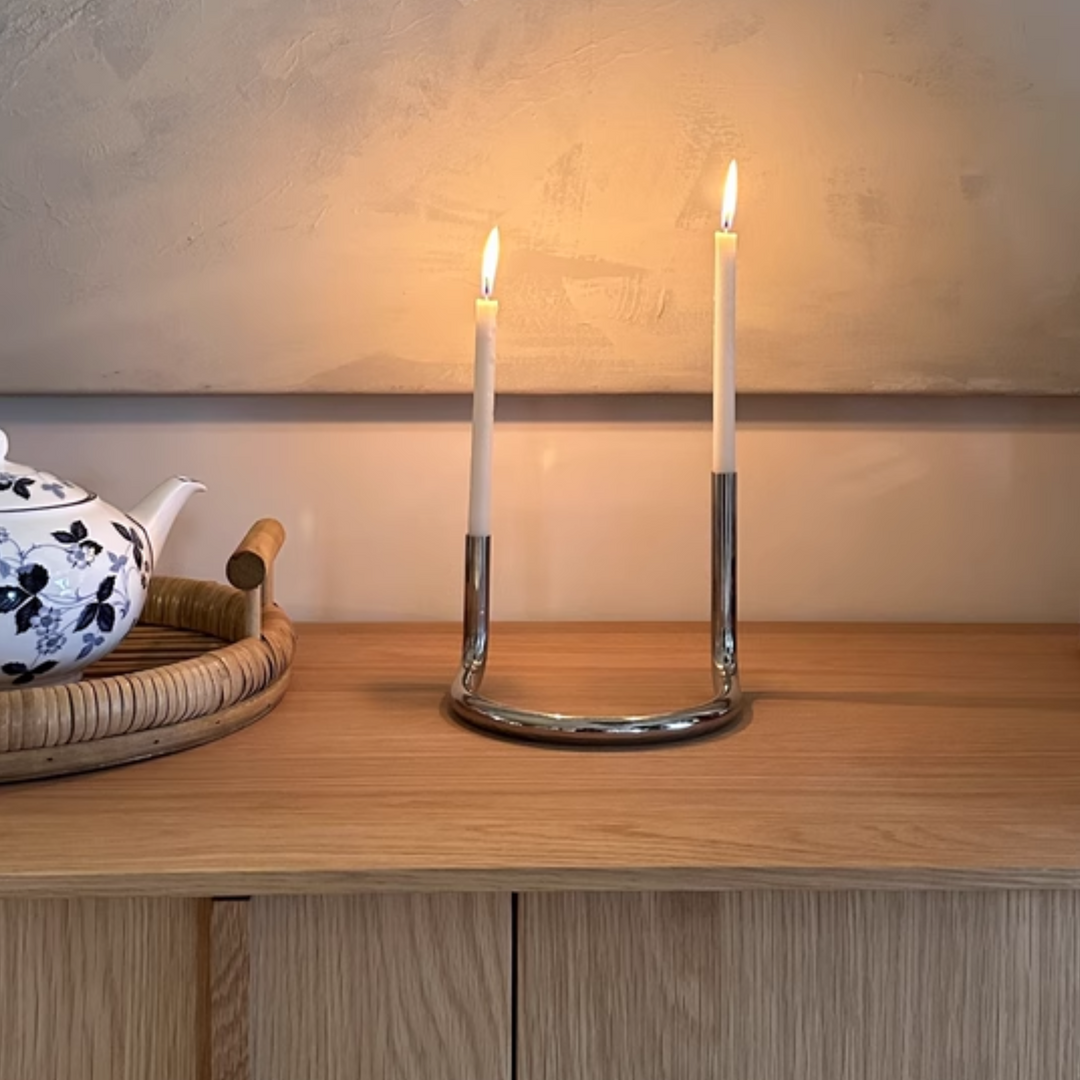 Elegant polished metal candle holder on a rustic surface, adding sophistication to contemporary homes.