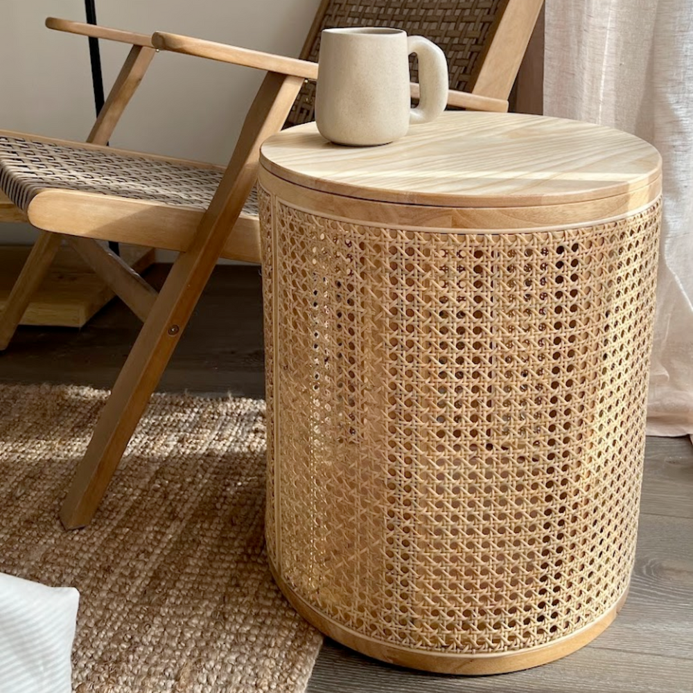 Rattan side table adorned with decorative items in a well-lit room