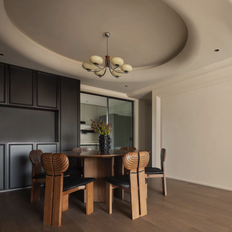 Retro modern pendant light illuminating a sleek dining room with warm tones and elegant design.