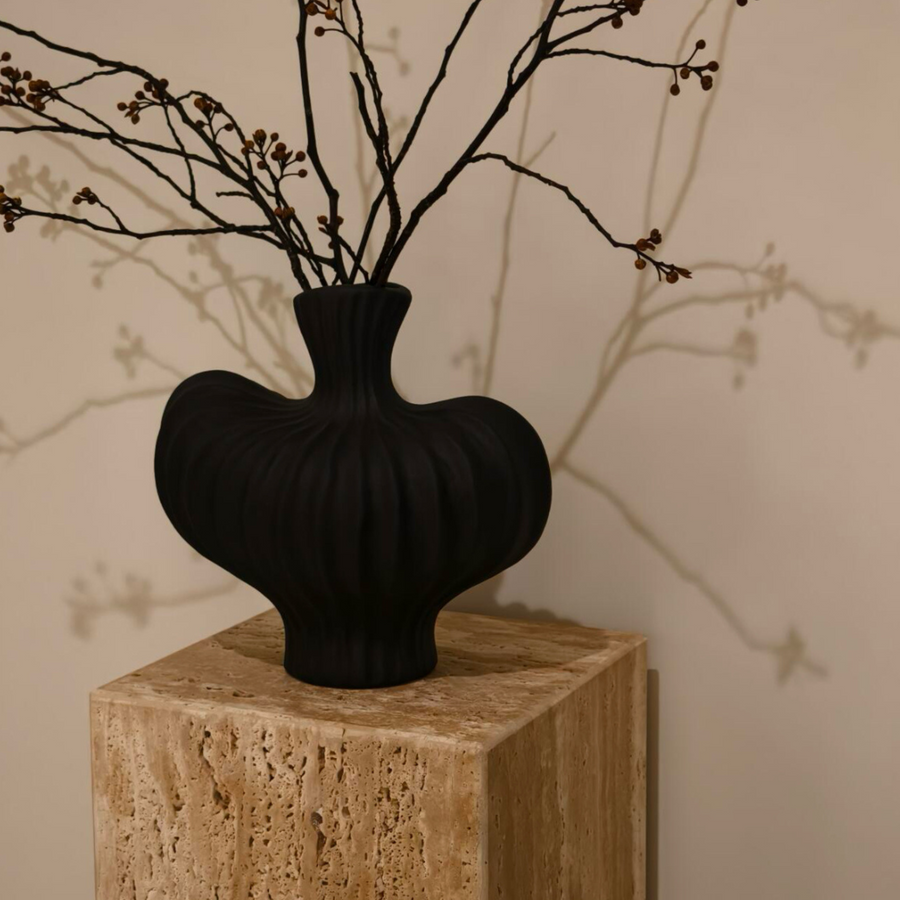 Black ceramic vase with sculptural wavy design for modern, Scandinavian, and minimalist decor.