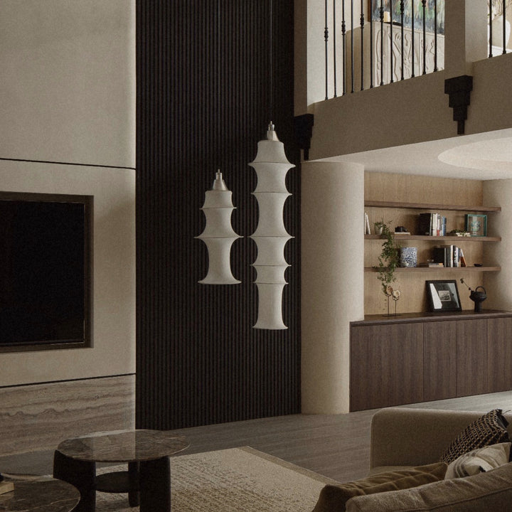 sculptural fabric pendant light hanging in a modern living room creating soft ambient lighting.