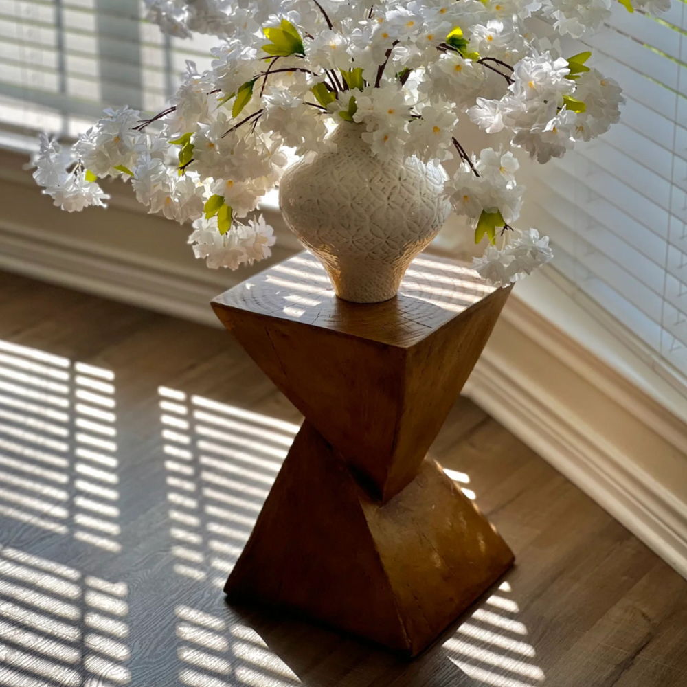 Side table in a minimalist bedroom setting with natural light