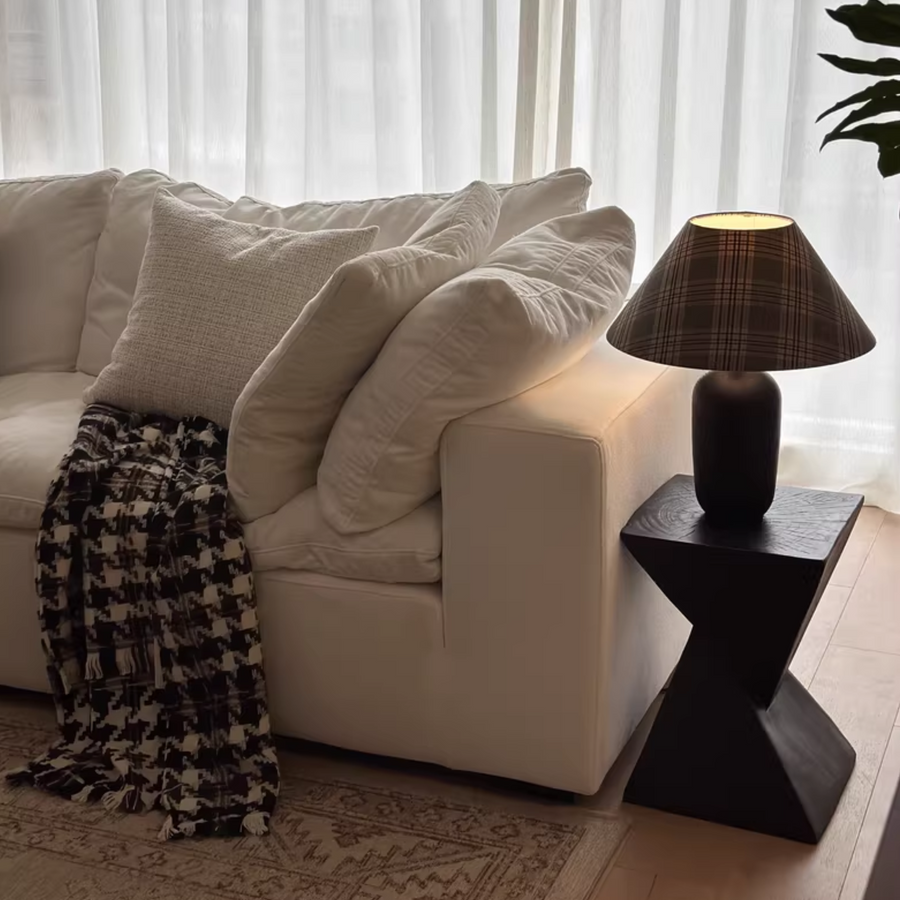 Side table in a cozy living room setup with a sofa and lamp