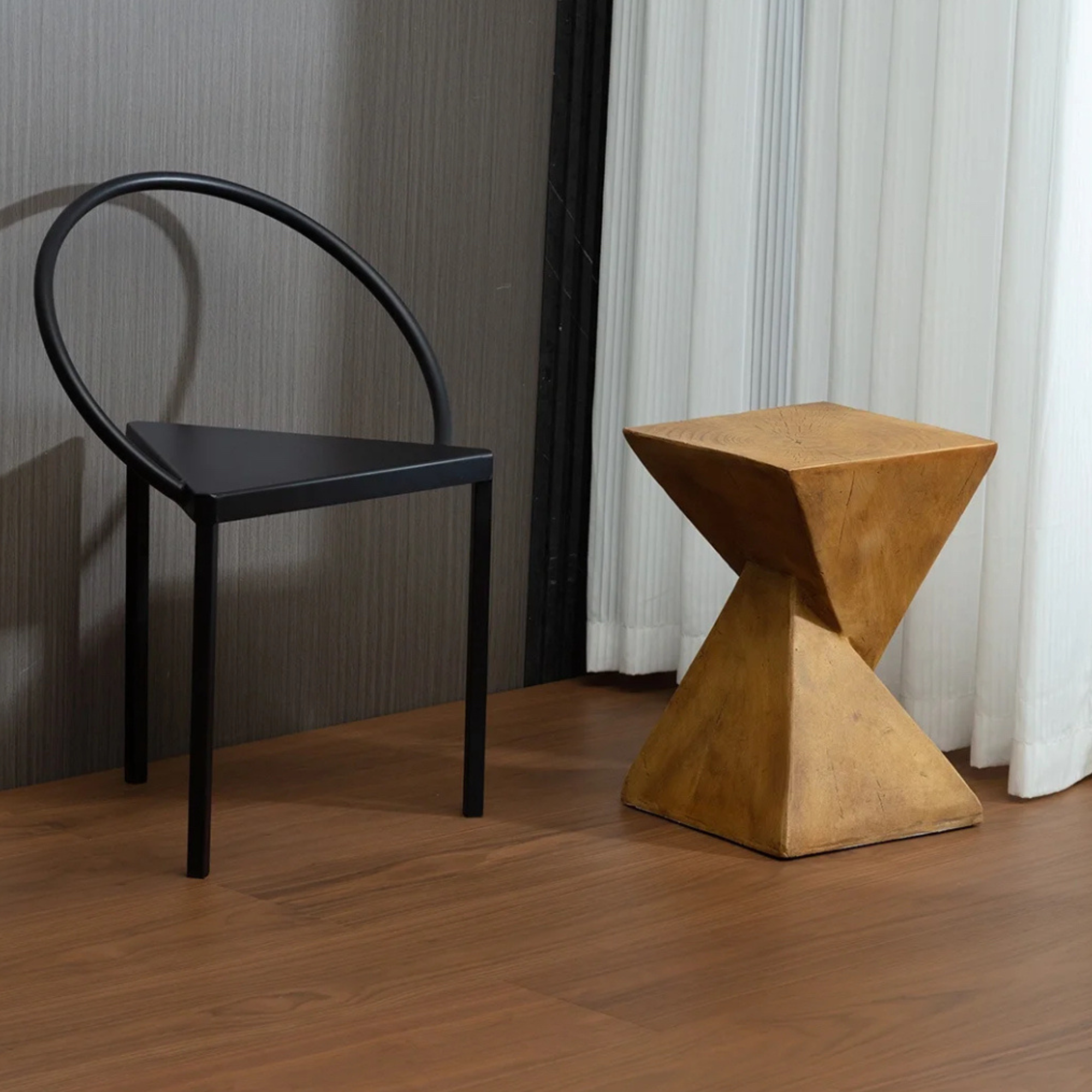 Side table paired with a modern black chair in a contemporary room