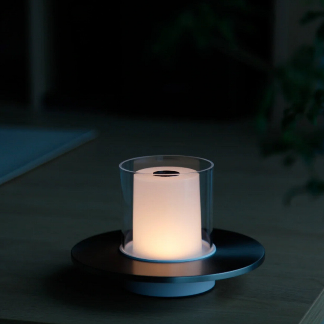 Sleek silver candlelight lamp providing a soft, intimate glow in a modern setting.