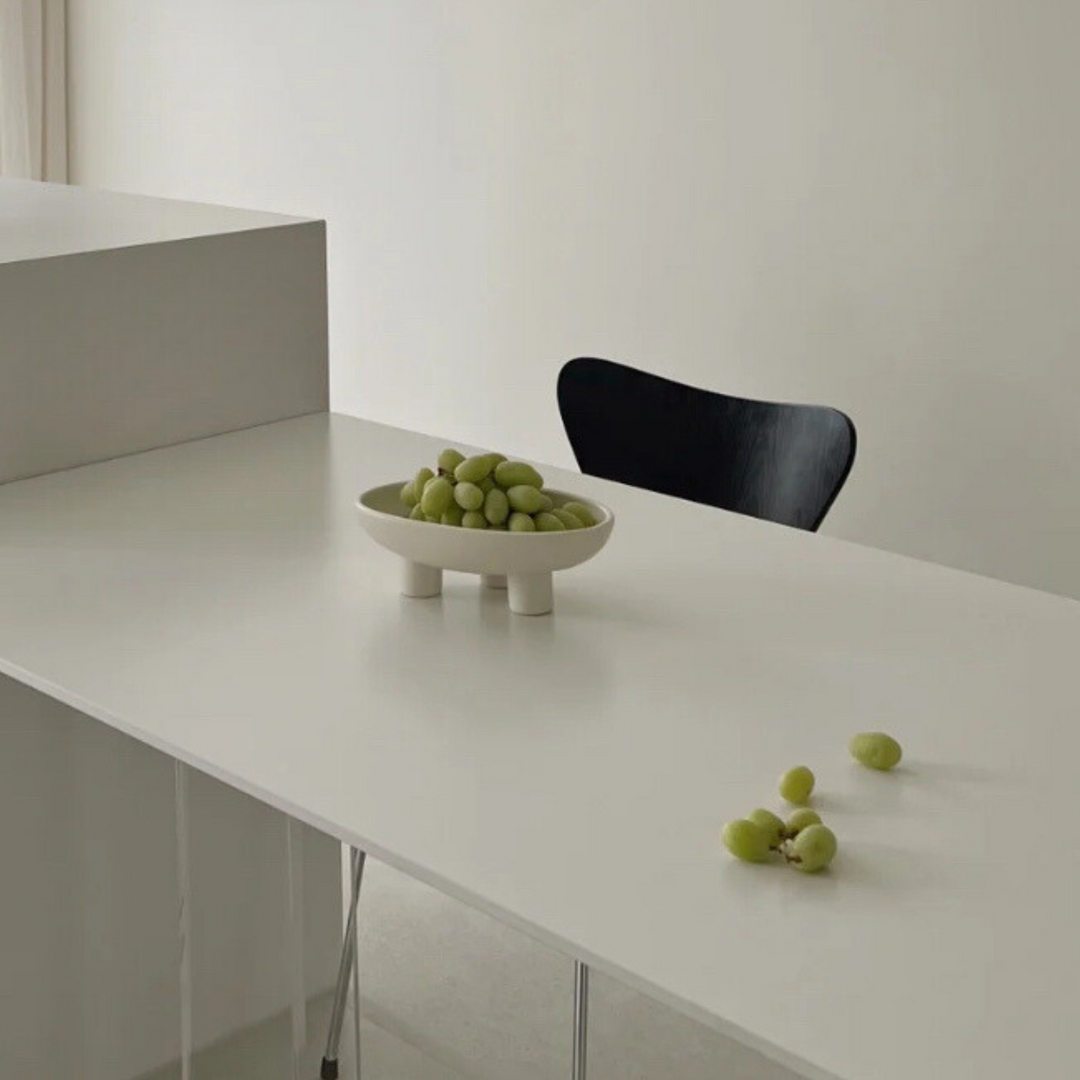 Clean and modern fruit bowl styled in a minimalist kitchen, highlighting its raised-leg design.