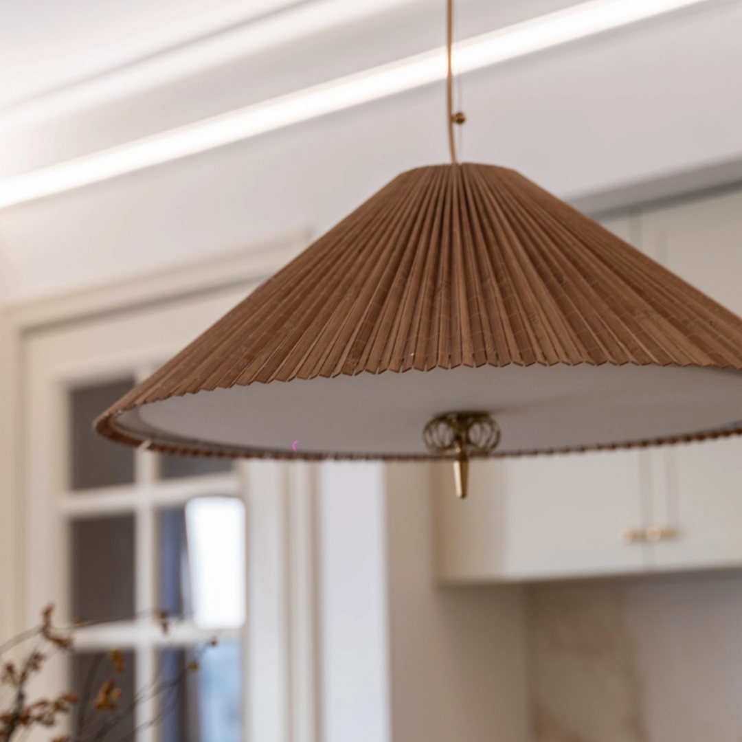 Soft neutral dining space featuring a woven bamboo pendant lamp