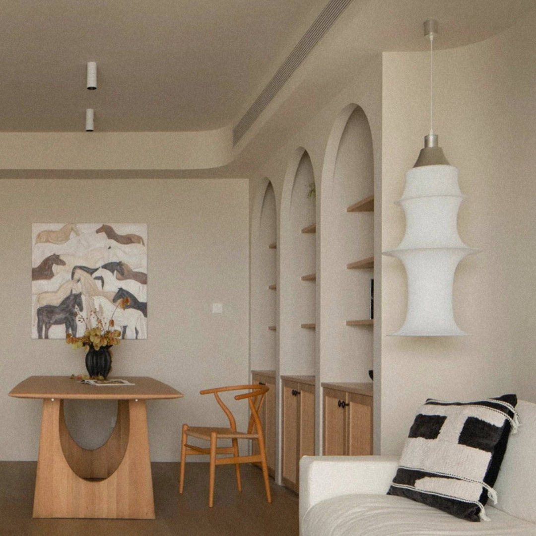 statement pendant light hanging above a dining area in a bright modern interior.