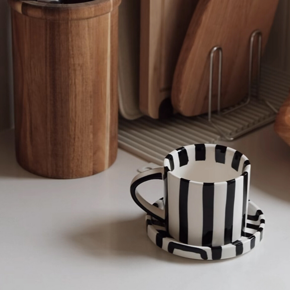 Chic striped ceramic mug placed in a contemporary kitchen setup, enhancing the decor.