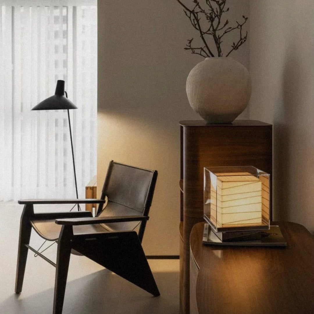 table lamp placed near a chair creating ambient lighting in a quiet corner.