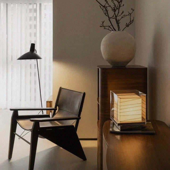 table lamp placed near a chair creating ambient lighting in a quiet corner.