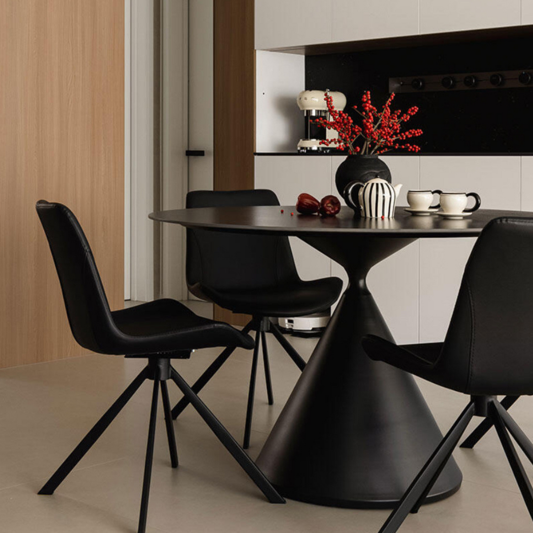 Tea set with teapot and mugs displayed on a modern dining table with chic decor.