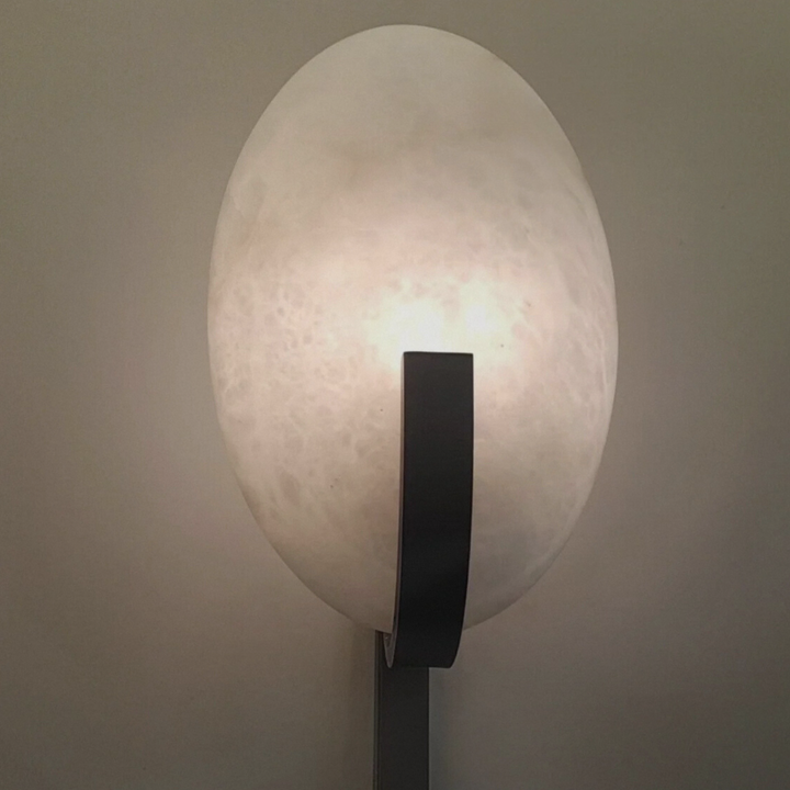 Elegant marble wall lamp mounted on a modern wall, perfect for minimalist and French-style interiors.