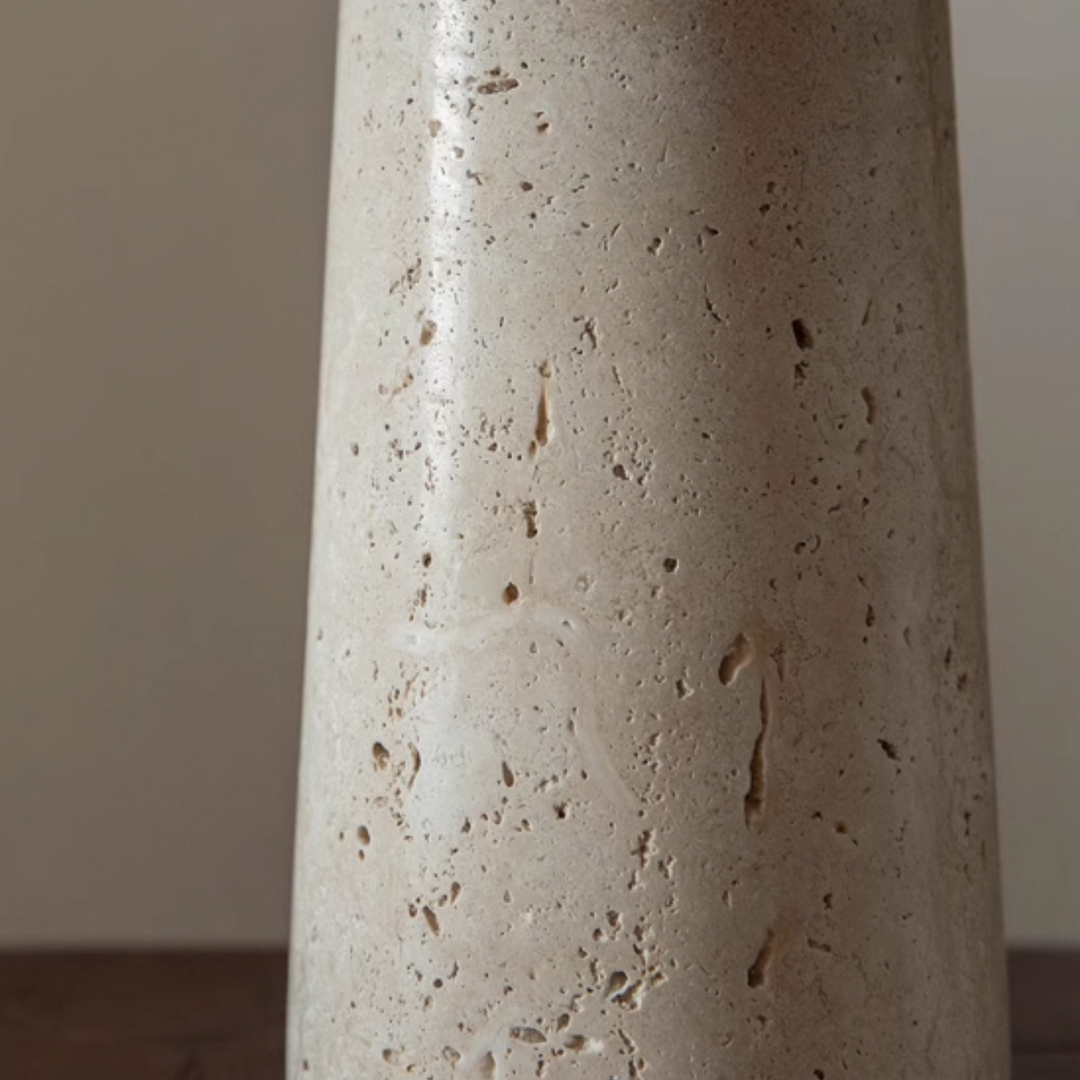 Closeup of the travertine base of the Jadea Table Lamp, showcasing its natural texture.