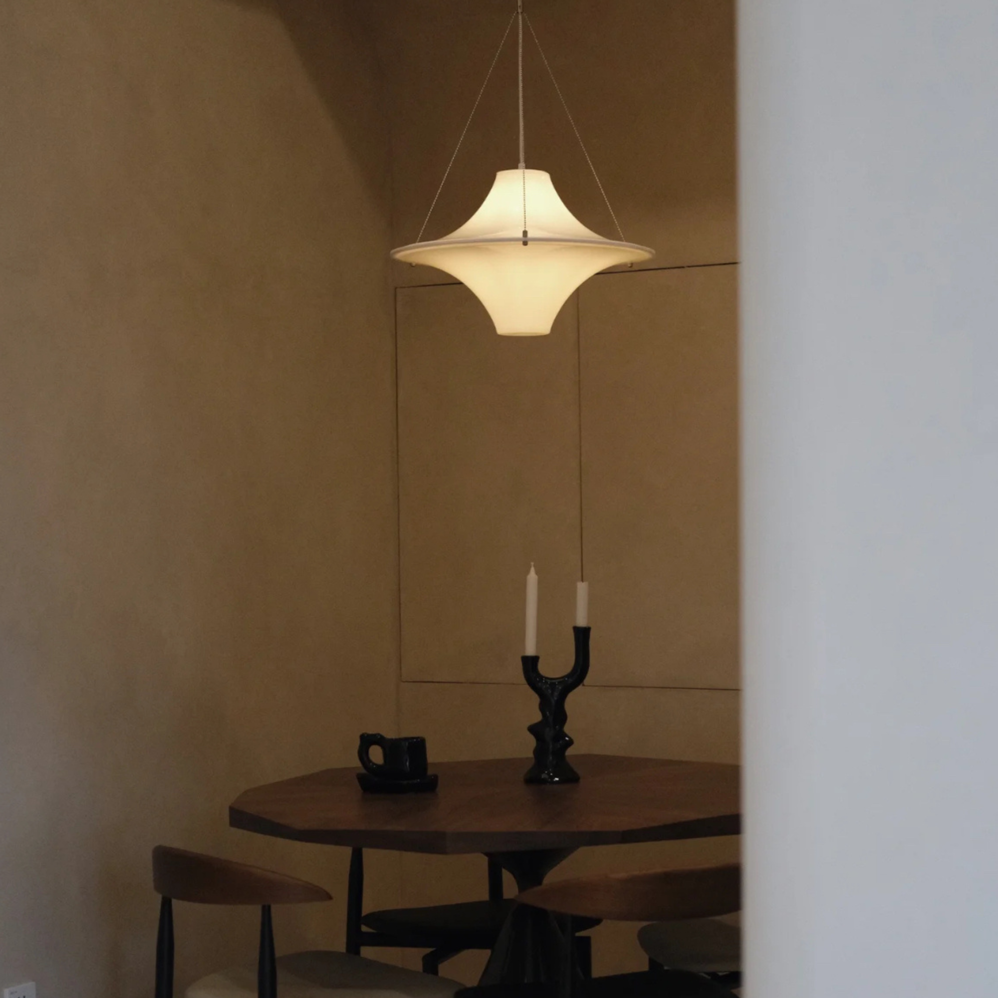 UFO shaped light fixture in a minimalist decor, creating a focal point in the room.