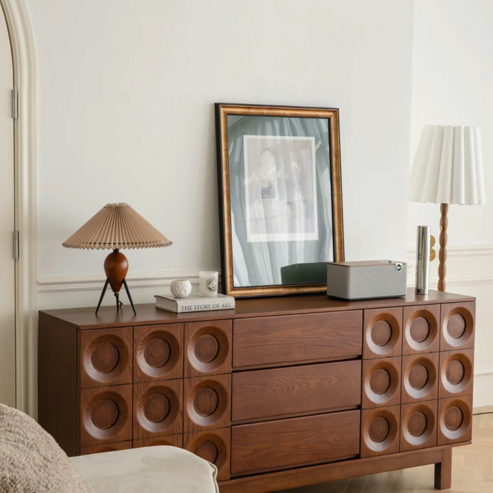 Vintage lamp positioned on a wooden dresser in a chic bedroom.