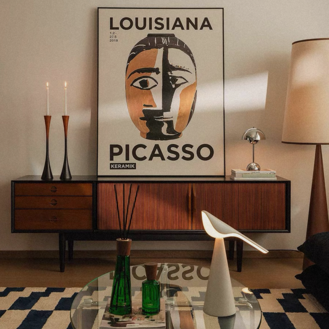 A set of sculptural two-tone wood candle holders styled in a warm, organic modern home.