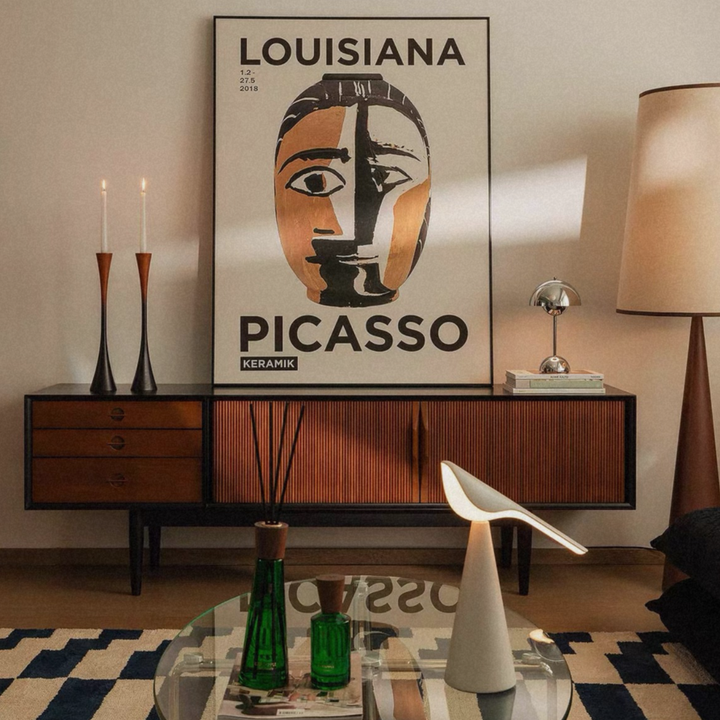 A set of sculptural two-tone wood candle holders styled in a warm, organic modern home.