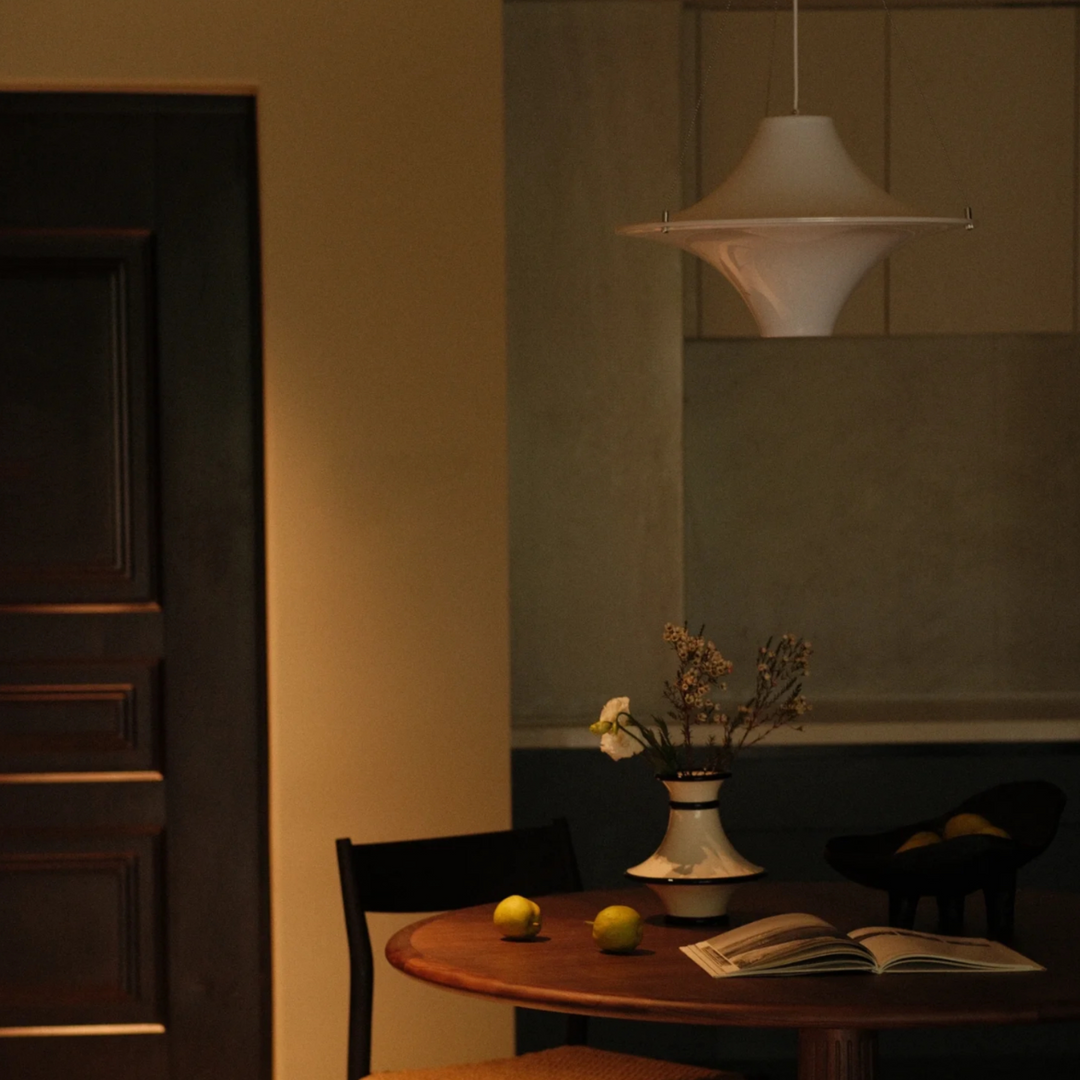 Warm light fixture enhancing the cozy ambiance of a dining room, ideal for relaxed gatherings.