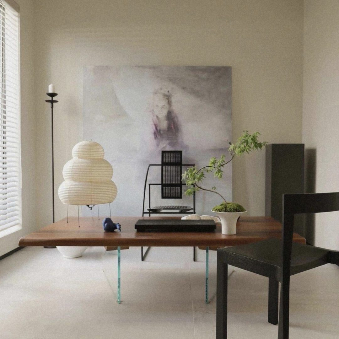 washi paper floor lamp placed beside a low table in a quiet modern interior.