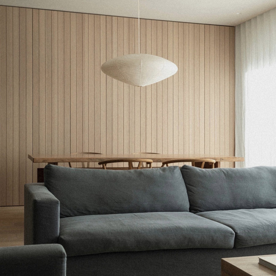 washi paper lantern ceiling light positioned above a sofa in a modern living space.