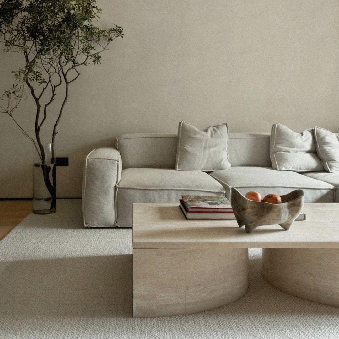 wood fruit bowl placed on a coffee table as a decorative centerpiece in a modern living room.