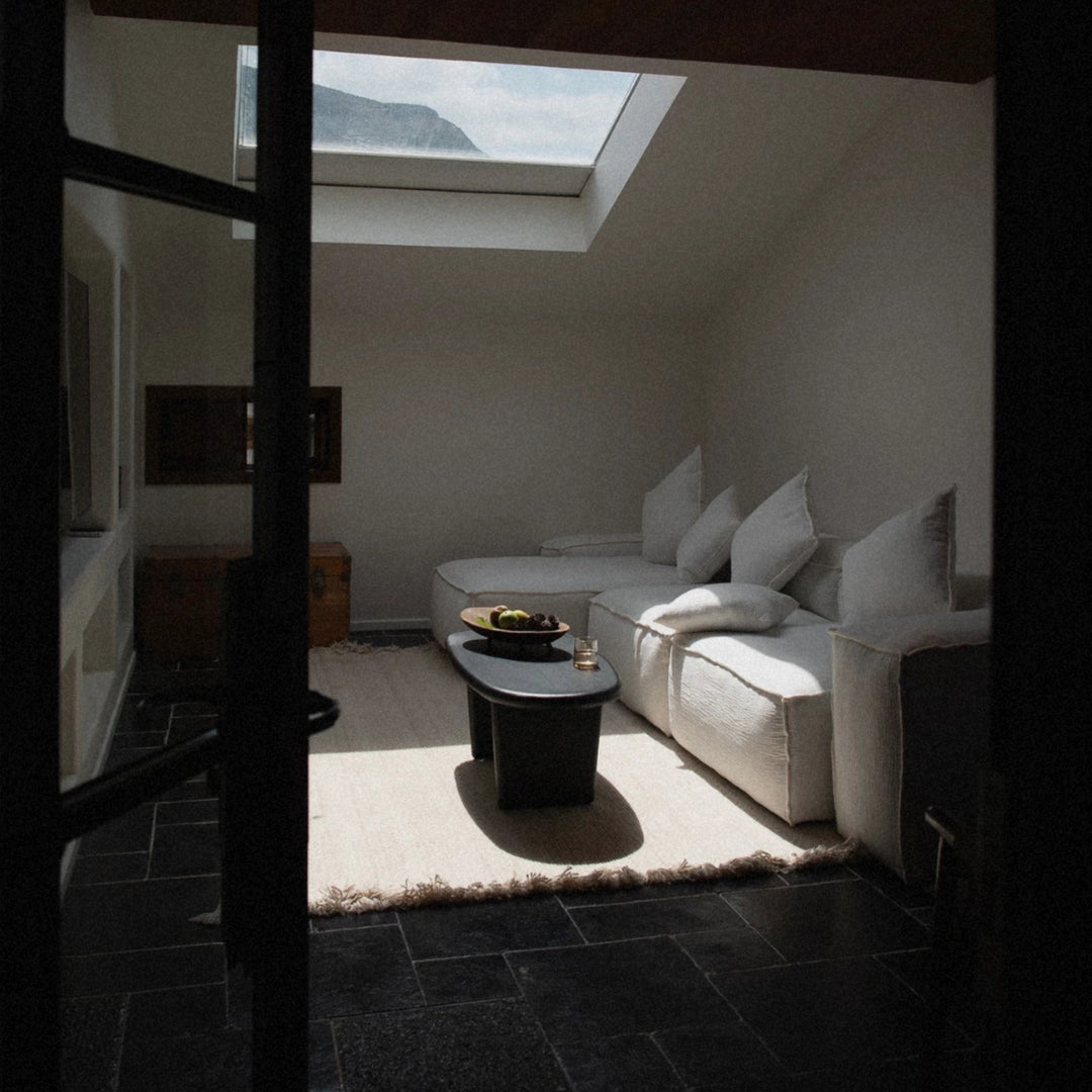 wooden centerpiece bowl placed on a table in a bright living room space.